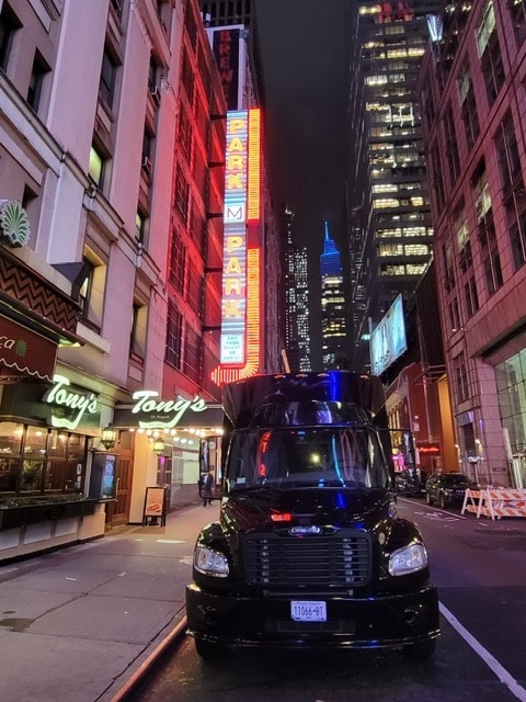 32-passenger executive bus in New York City at night