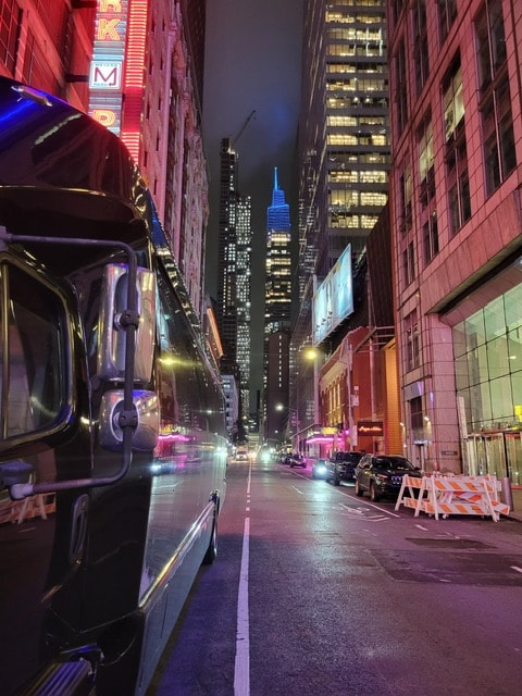 32-passenger executive bus on NYC street at night