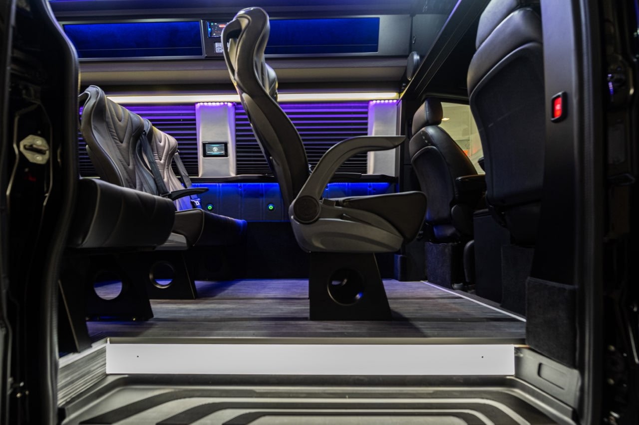 Executive Sprinter interior with captain chairs and purple ambient lighting